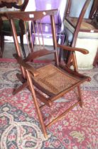 Late 19th / early 20th Century folding campaign chair with a spindle back and cane seat