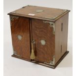 Early 20th Century oak two door smokers compendium, with silver plated mounts