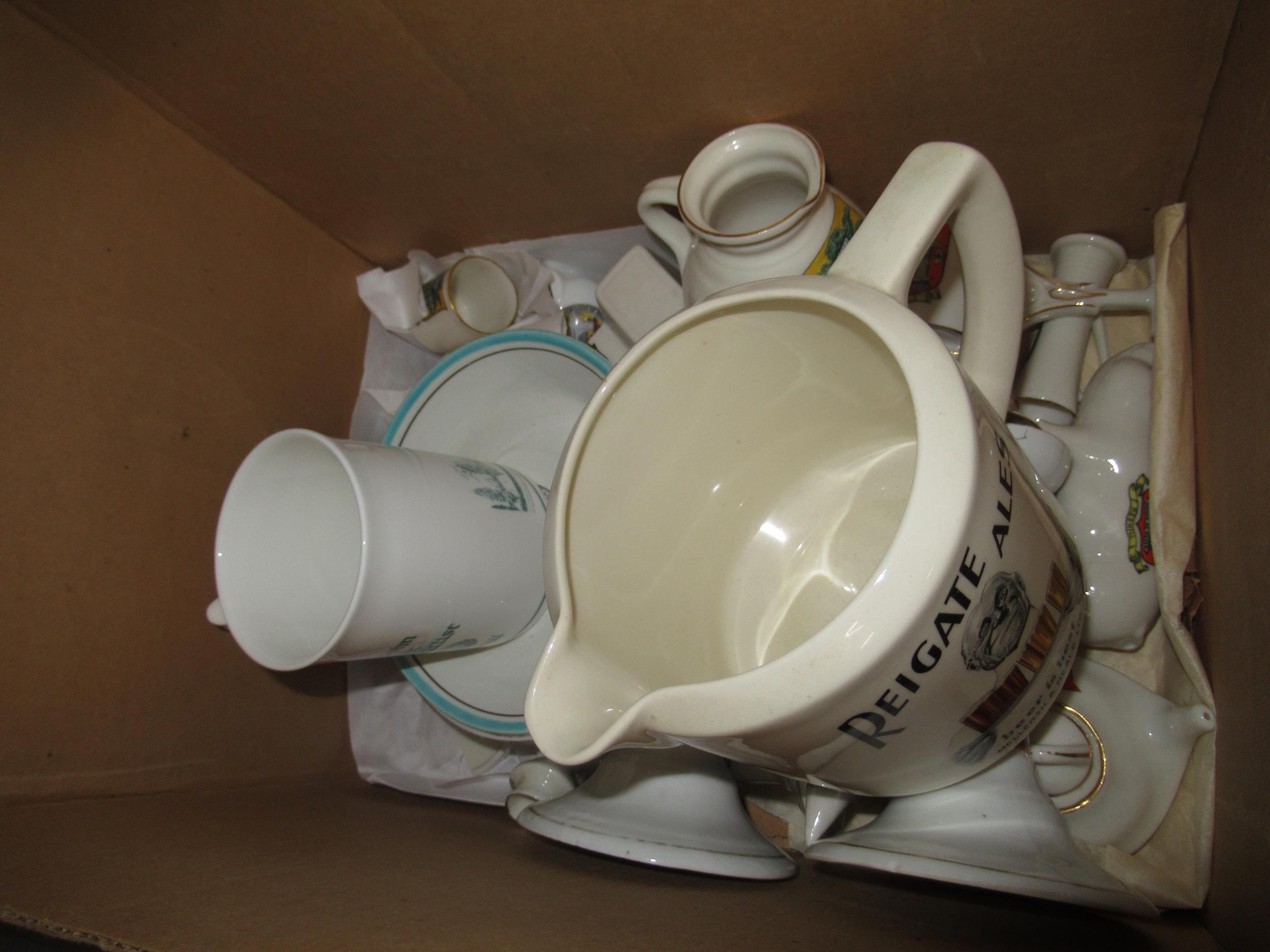 Box of crested China related to Redhill and Reigate, also including a Reigate Ales Royal Doulton jug