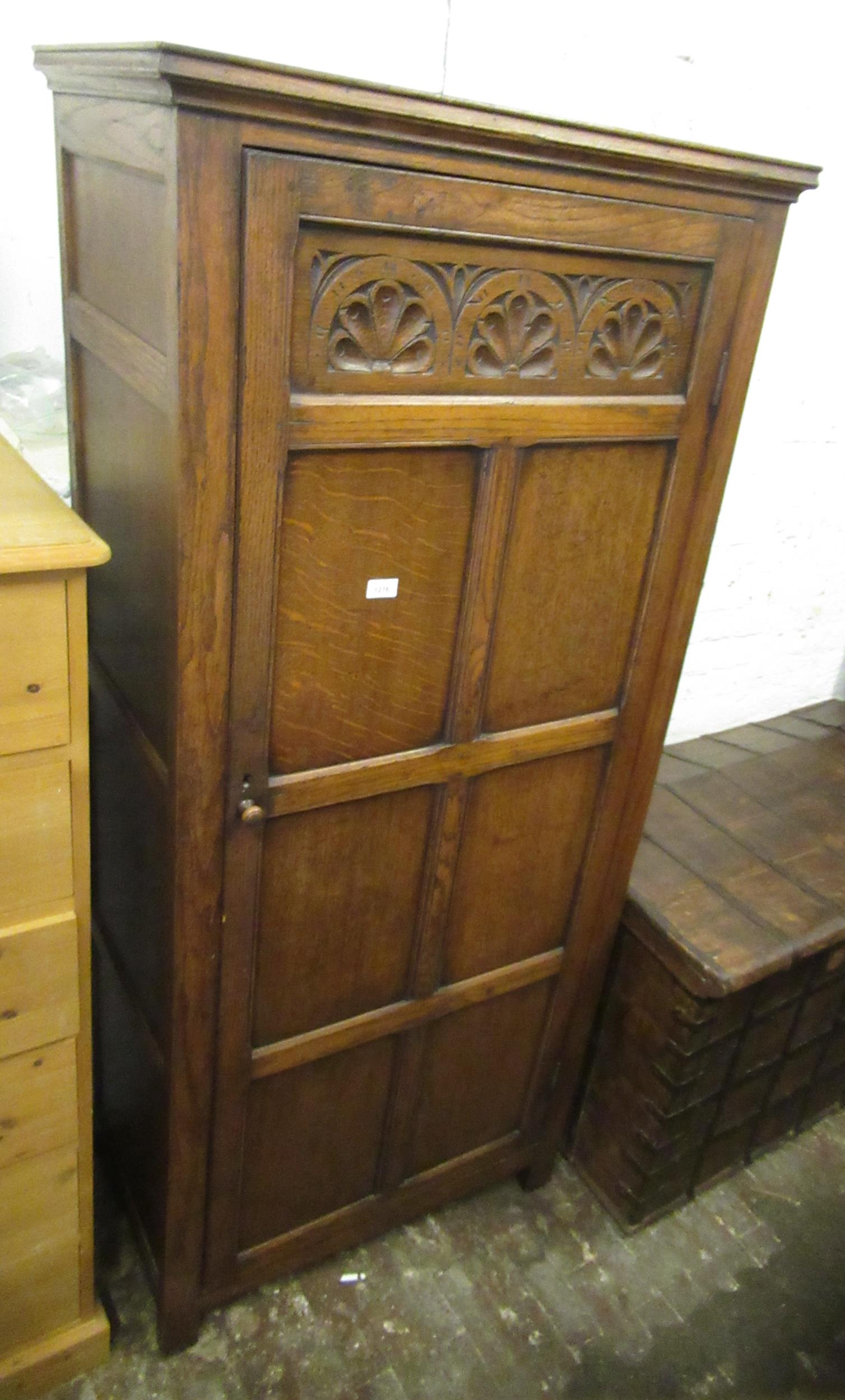 Good quality reproduction oak hall wardrobe with a single carved and panel door