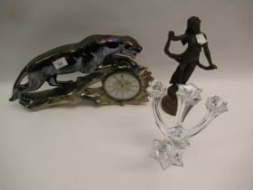 Pottery mantel clock in the form of a panther, together with a four branch glass candelabra and a