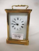 Modern brass cased carriage clock having enamel dial with Roman numerals, including key, 12cm high