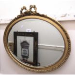 Oval gilt framed wall mirror with bevelled plate, together with a reproduction mahogany wall hanging