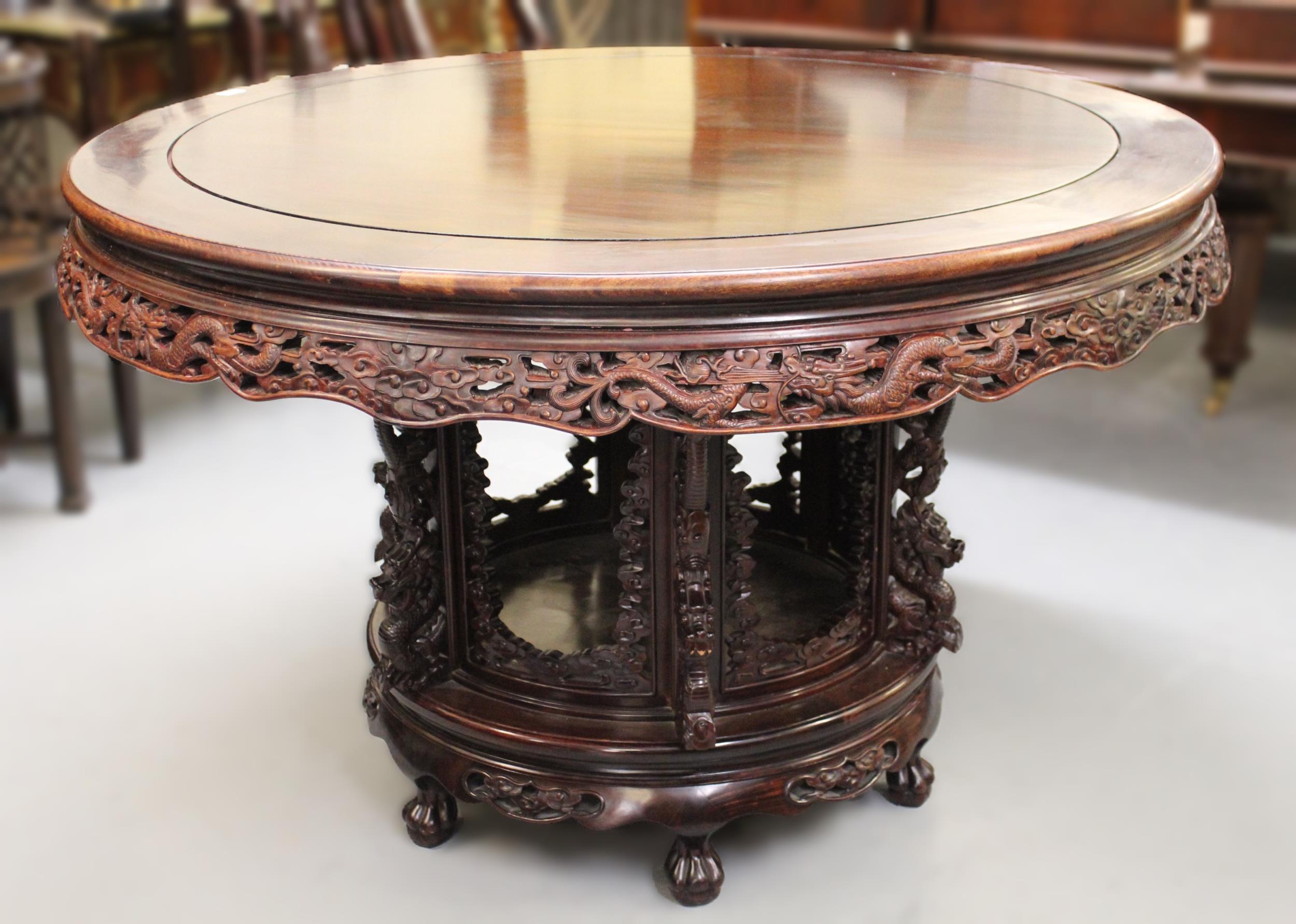 Good quality Chinese hardwood centre table with carved and pierced frieze, raised on a carved base