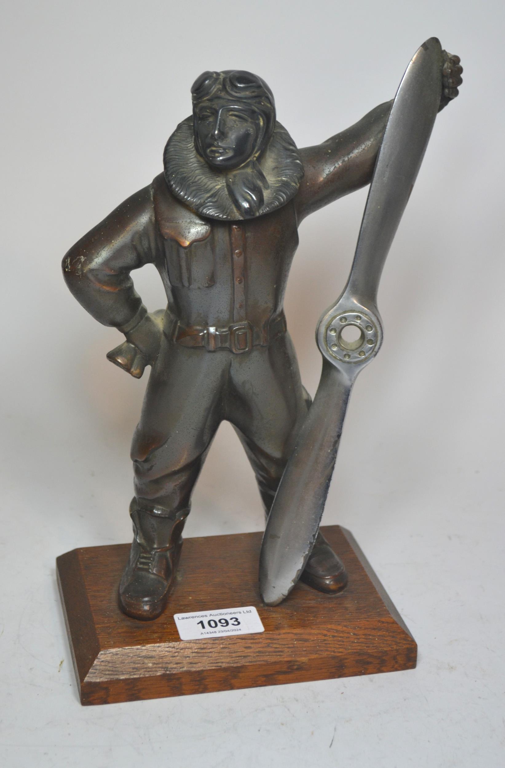 Mid 20th Century patinated spelter table lighter in the form of an aviator on an oak plinth base,