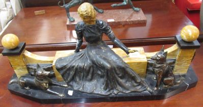 Art Deco painted and patinated spelter group of a seated girl with two dogs before a decorative