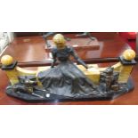 Art Deco painted and patinated spelter group of a seated girl with two dogs before a decorative