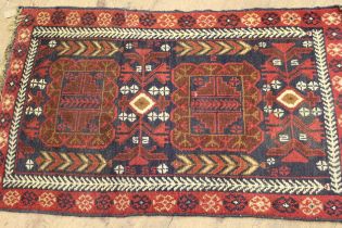 Small Afghan rug of medallion design on a burgundy ground, 140 x 80cm