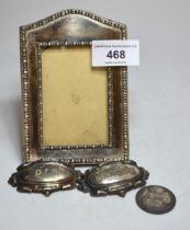 Small rectangular silver photograph frame, pair of plated wine labels and a silver plated 1910 one