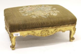 Small Victorian giltwood footstool with floral decorated top on cabriole supports, 44cm wide