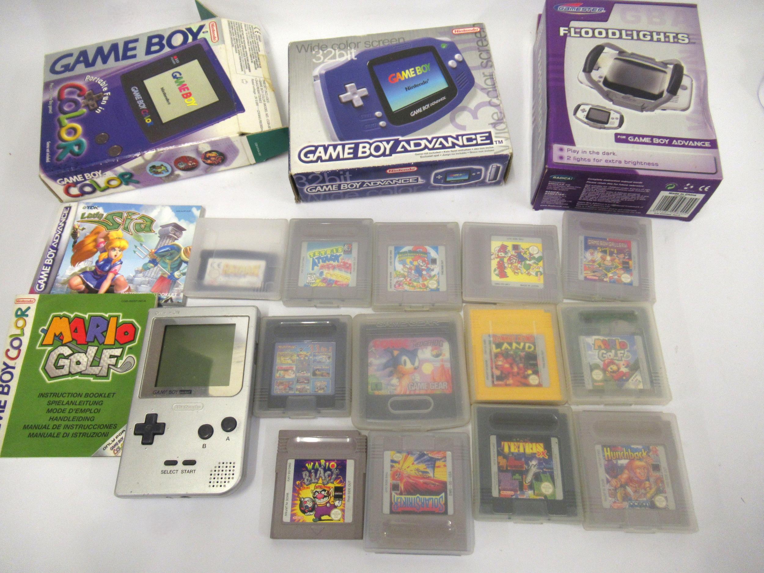 Two boxed Nintendo Game Boy units, including a quantity of various cassette games