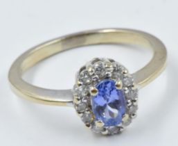 Small 18ct gold tanzanite and diamond oval cluster ring Size between K and L