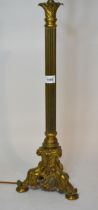 Brass column form lamp base on decorative gilt brass triform base, 66cm high