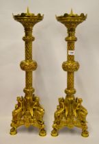 Pair of fine quality gilt brass altar candlesticks of Gothic design, the triangular bases each