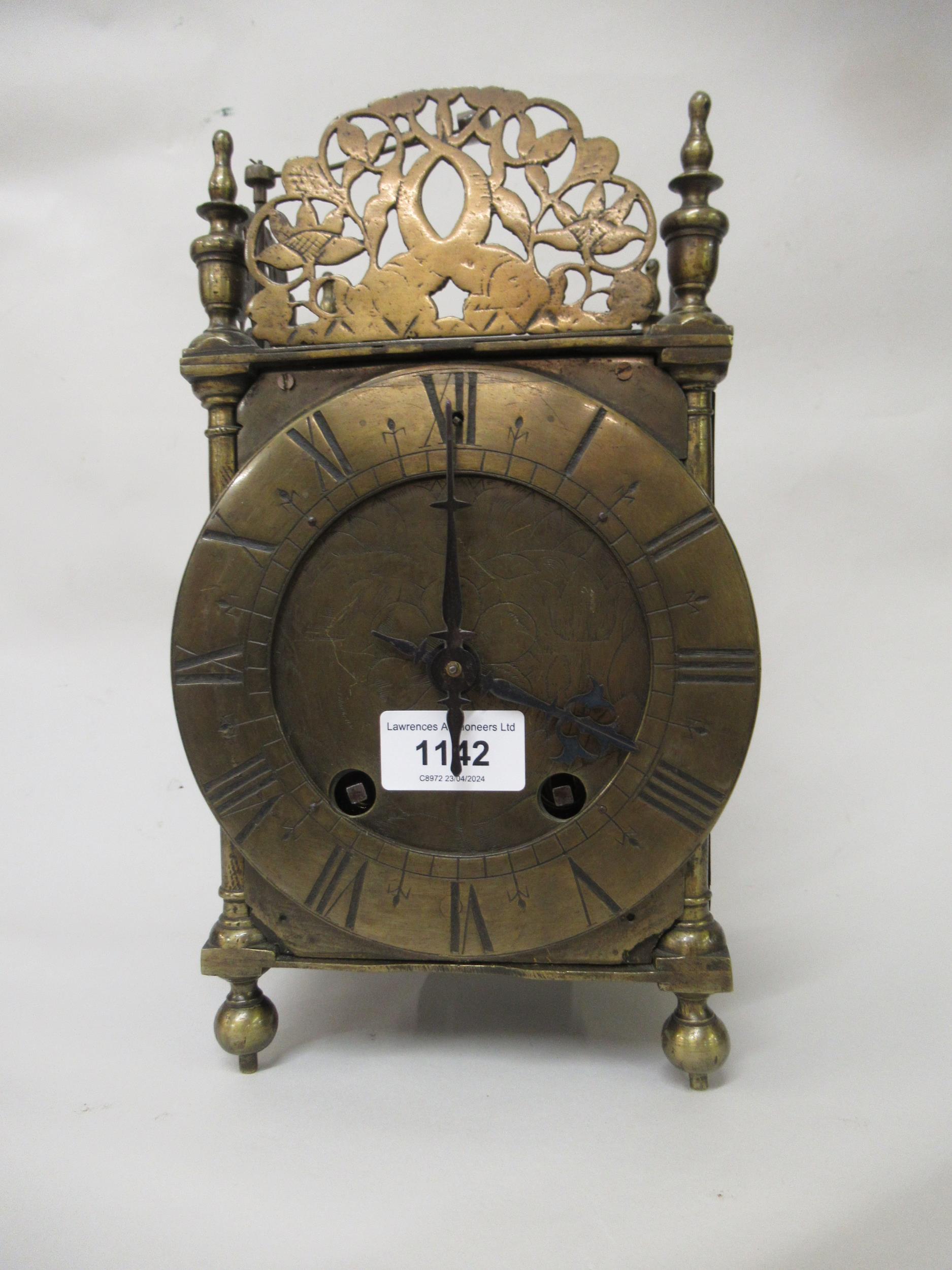 Brass lantern clock, the pierced surmount above an engraved circular dial with Roman numerals, the