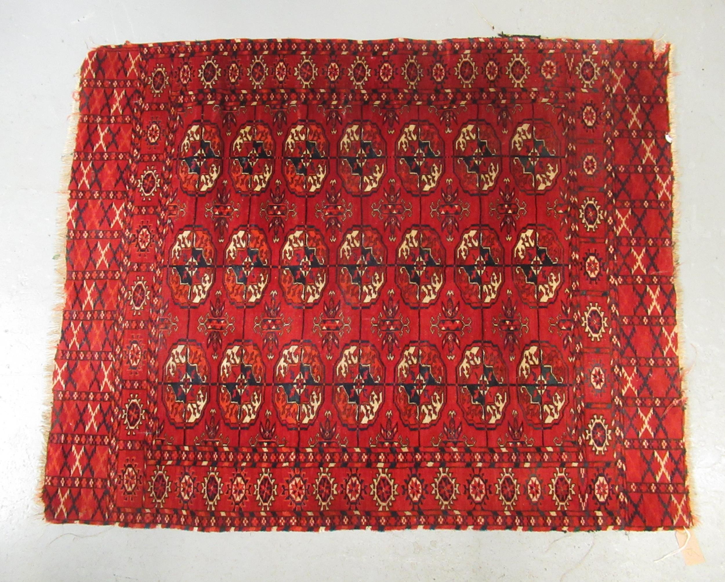 Small Tekke rug with three rows of seven gols on a wine ground (borders reduced)