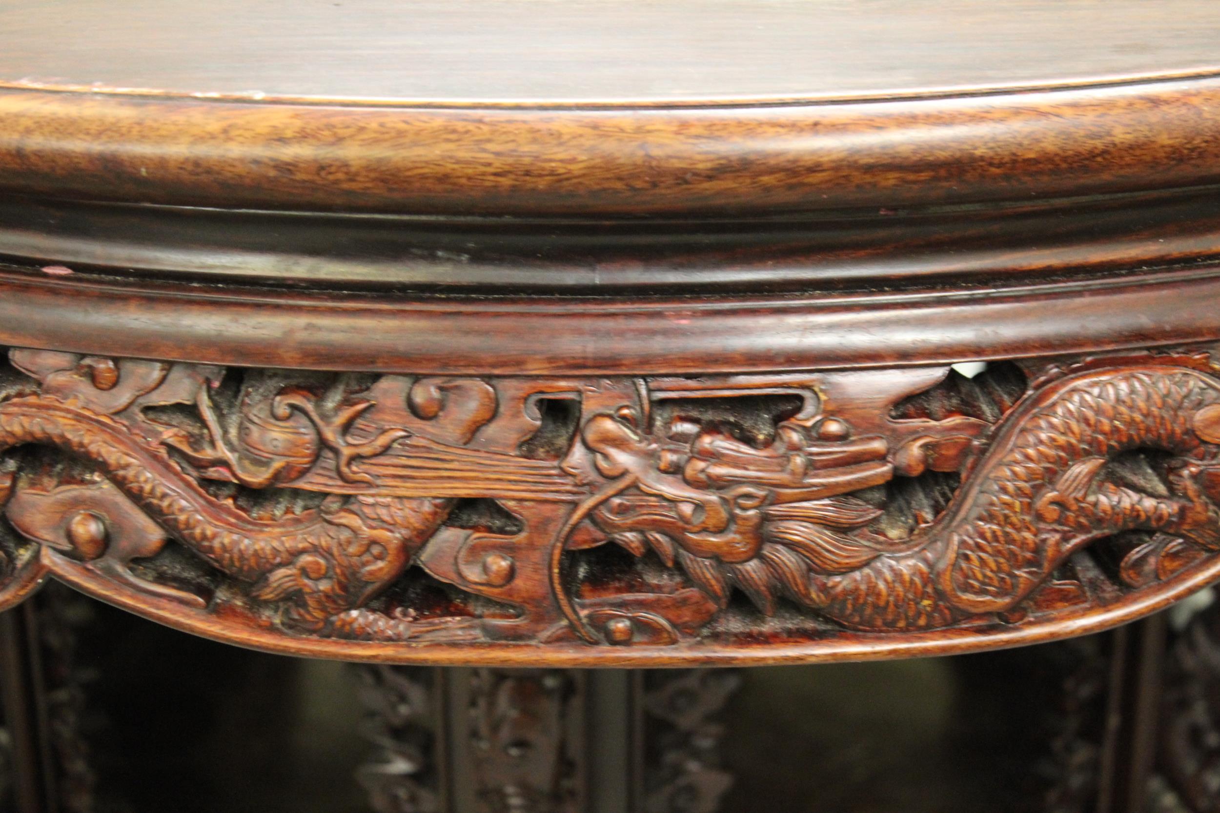 Good quality Chinese hardwood centre table with carved and pierced frieze, raised on a carved base - Image 2 of 3