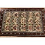 Modern oriental rug with repeating oval floral panel design within a dark border, 121 x 77cm