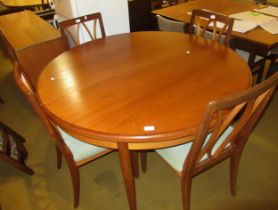 20th Century G Plan circular extending dining table on tapering supports, with integral leaf,