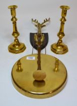 Brass wall mounted dinner gong and a pair of antique brass candlesticks