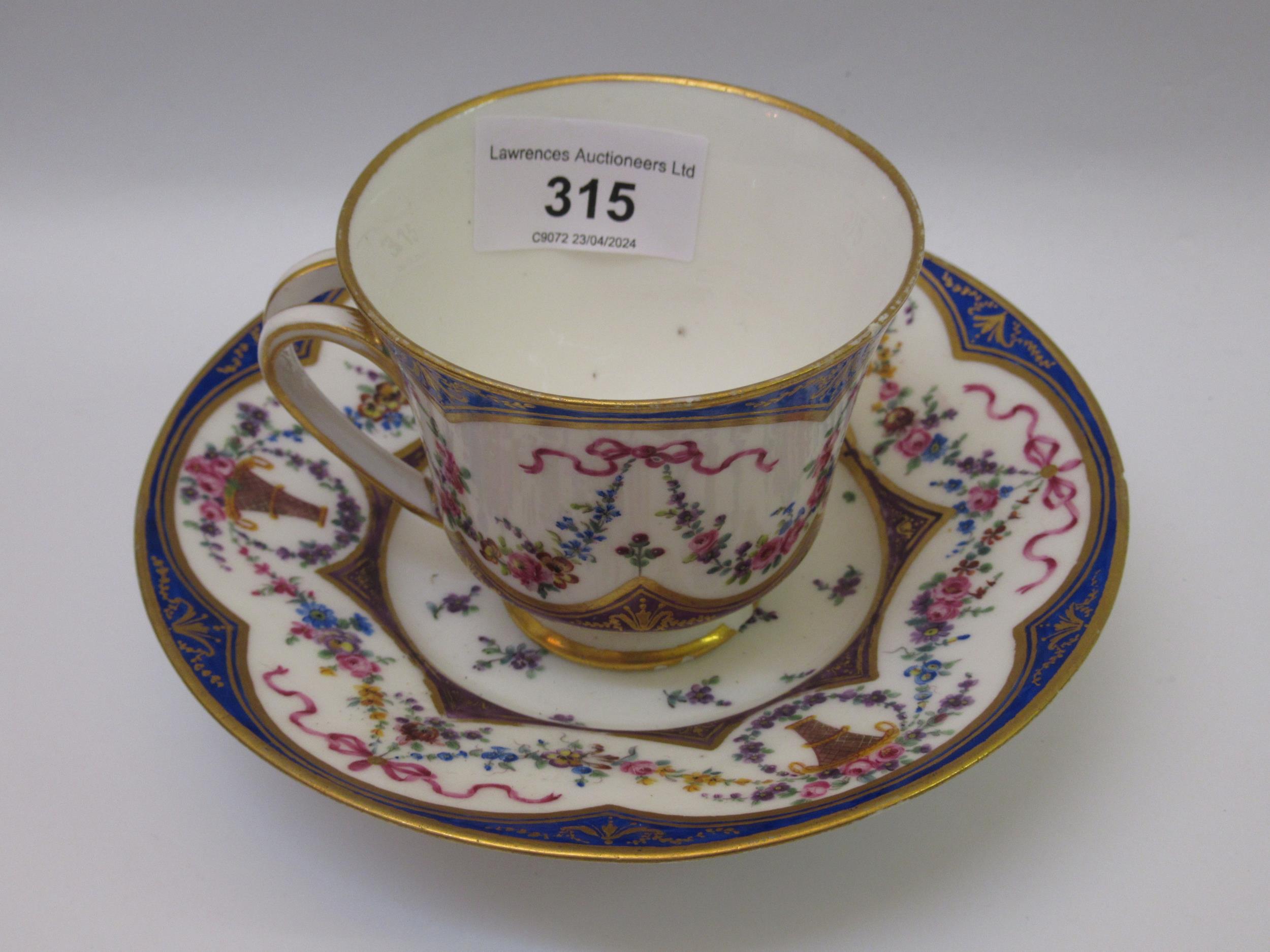 Sevres porcelain cabinet cup and saucer with floral and swag decoration Various chips, as shown in