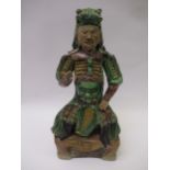 Chinese pottery figure of a seated warrior, 25cm high Various damages, condition as shown in photos