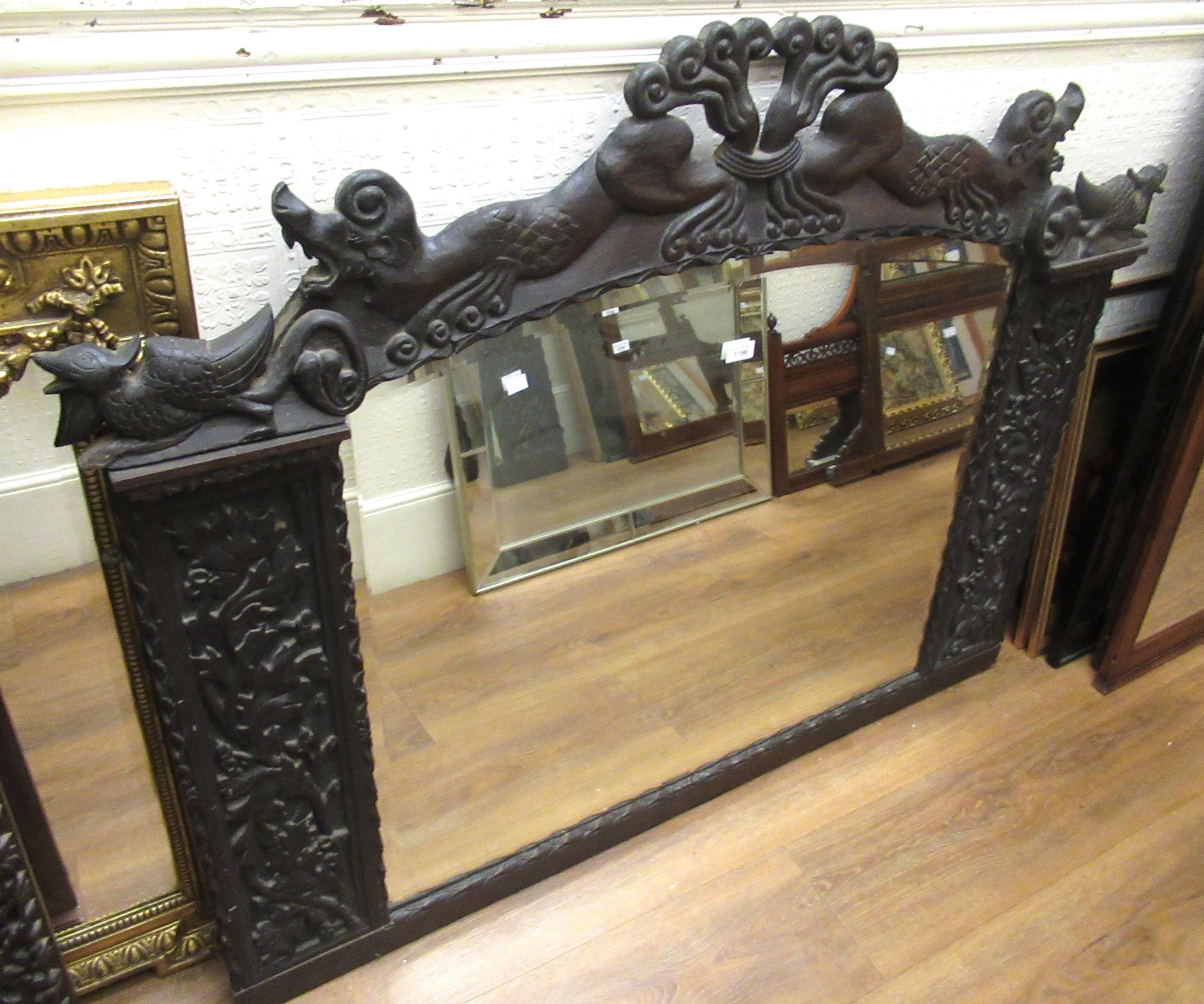 Large Continental carved oak overmantel mirror, the top surmounted with figures of animals, having