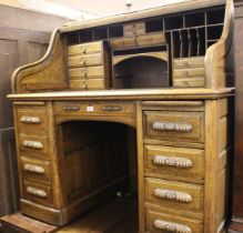 Good quality oak roll top tambour fronted desk enclosing a fitted interior of various shelves and