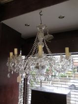 Modern glass eight light electrolier with scroll shaped arms, baluster centre column and various