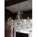 Modern glass eight light electrolier with scroll shaped arms, baluster centre column and various