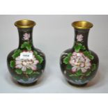 Pair of cloisonne baluster form floral decorated vases on a black ground, 21cm high