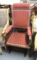 Late Victorian oak rocking chair with padded back, arms and seat and spindle decoration