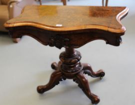 Victorian figured walnut serpentine fronted fold-over card table, on cabriole supports with casters,