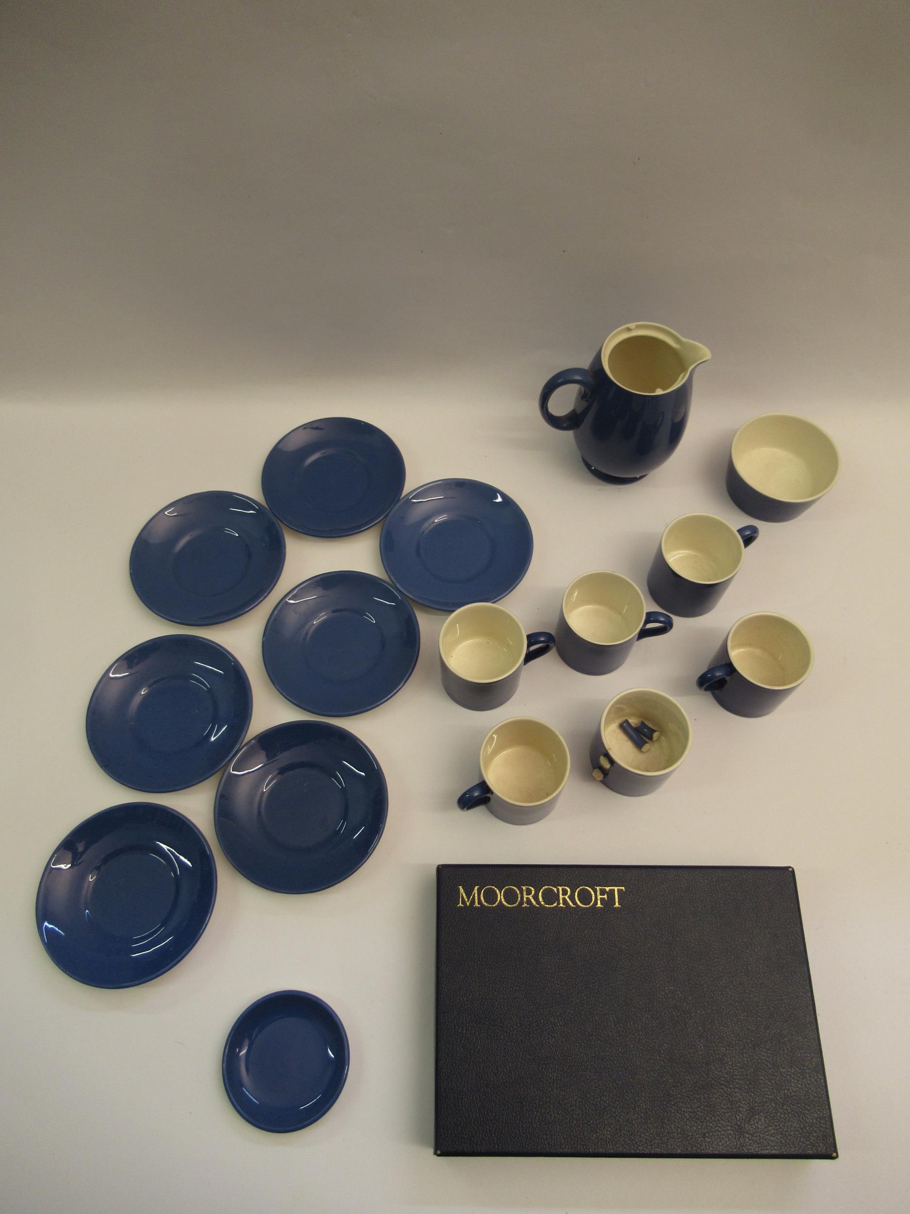 Moorcroft blue glazed part coffee service comprising: six coffee cans (one at fault), six saucers,