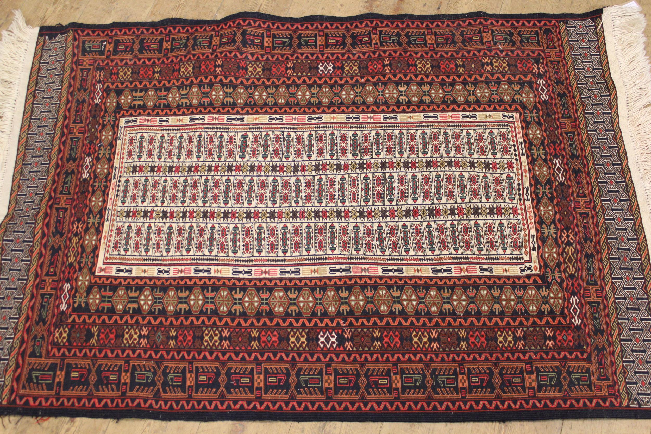 Soumak rug with centre panel and multiple borders on a wine ground, 150 x 94cm