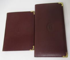 Must de Cartier, burgundy leather wallet and another burgundy wallet