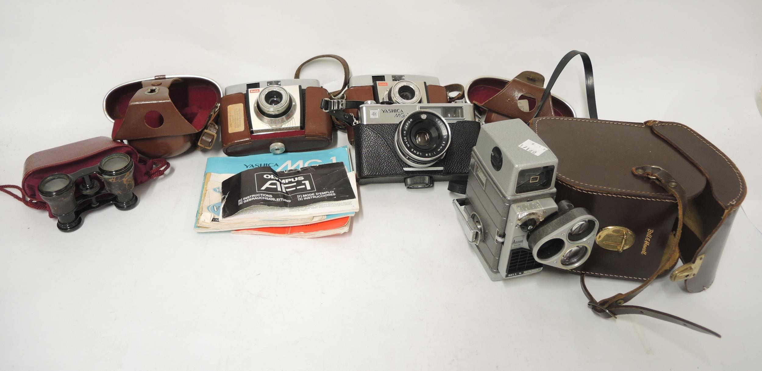 Pair of opera glasses in partial leather case, three various cameras and a Bell & Howell cine camera