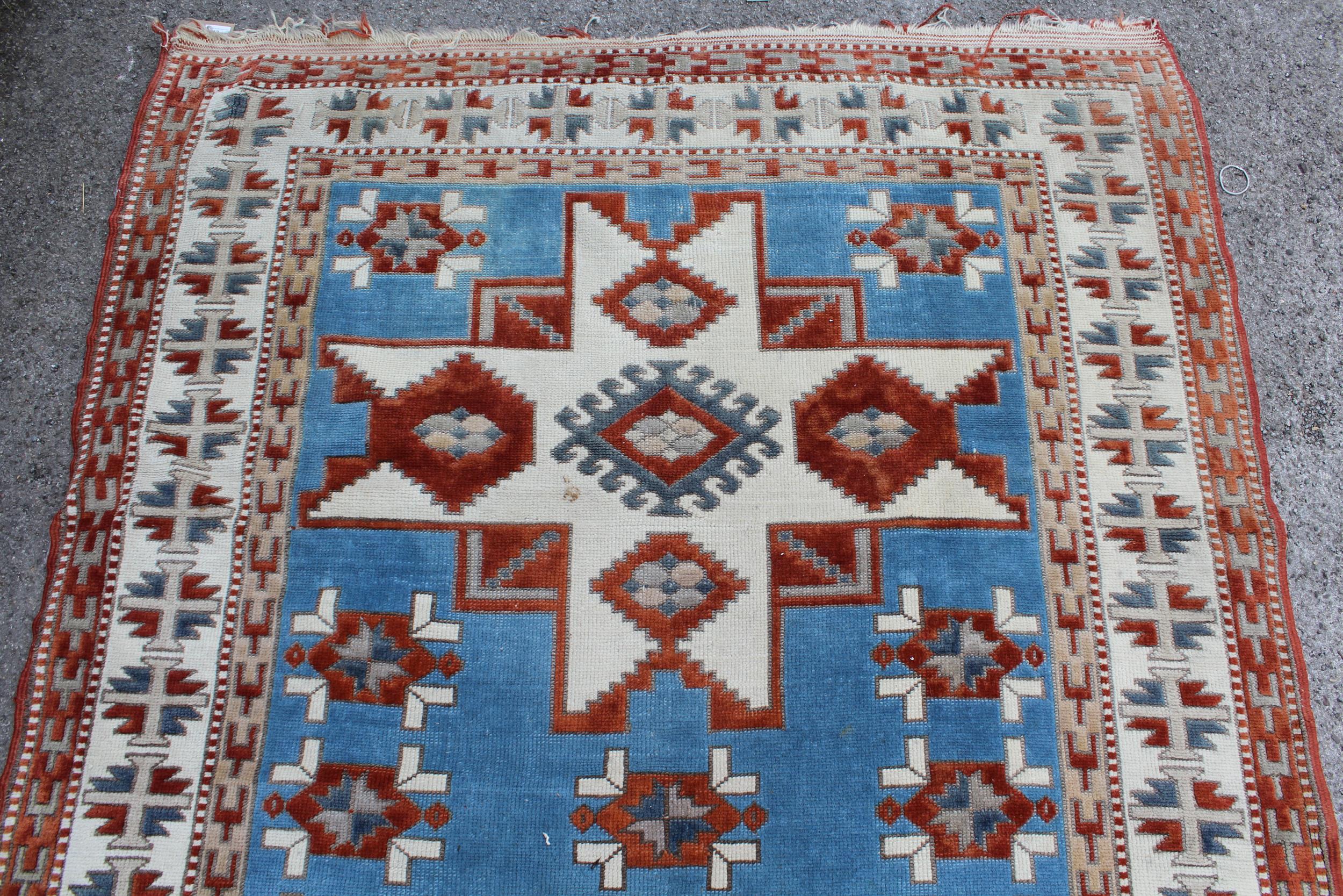 Kazak rug having two hooked medallions on a cream and pale blue ground with multiple borders, 1.5 - Image 3 of 3