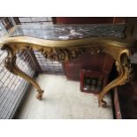 Early 20th Century carved and gilded console table, the shaped marble inset top above a pierced