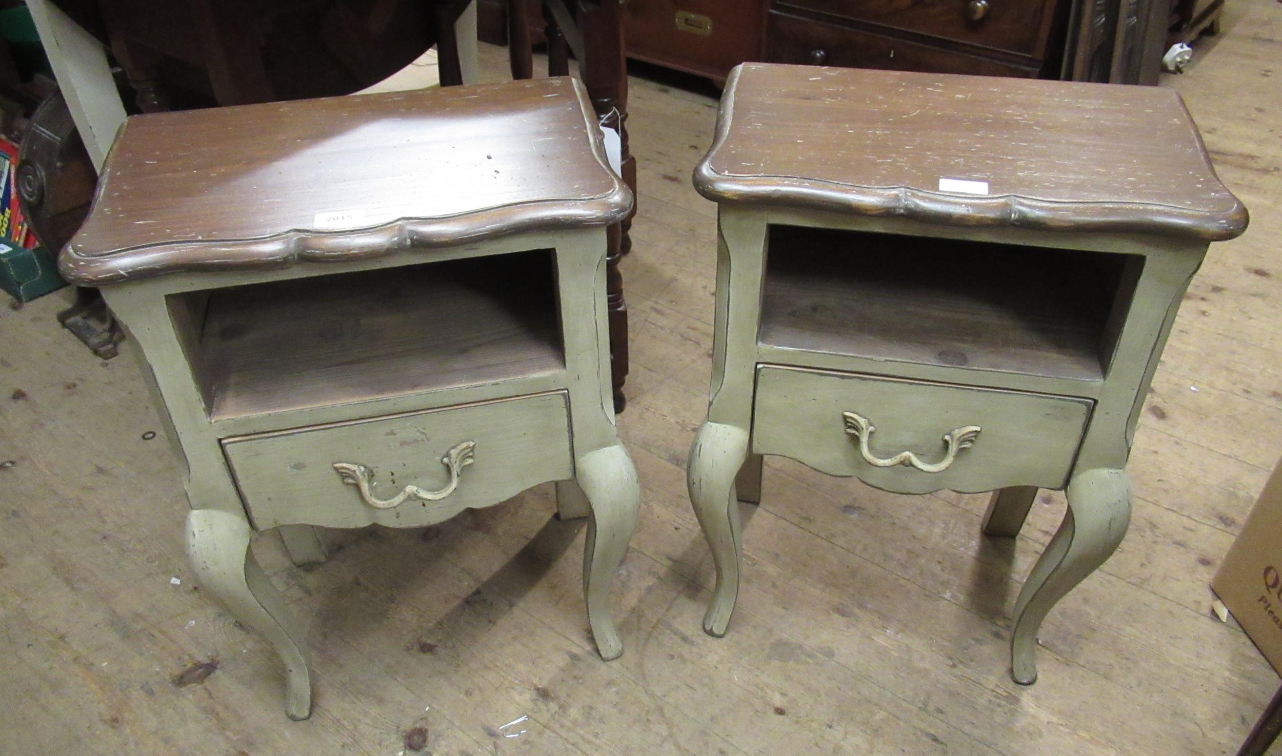 Pair of French green distressed painted bedside tables, with alcoves above drawers on cabriole