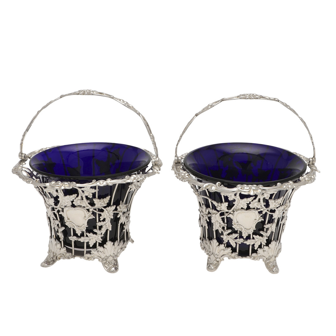 A PAIR OF VICTORIAN SILVER SWING-HANDLE SUGAR BASKETS.