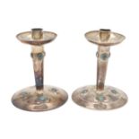 A PAIR OF EDWARDIAN ARTS & CRAFTS SILVER CANDLESTICKS, BY A. E. JONES.