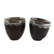 A PAIR OF SILVER MOUNTED COCONUT CUPS.
