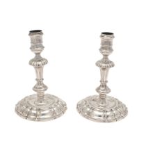 A PAIR OF GEORGE II CAST SILVER CANDLESTICKS.