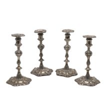 A SET OF FOUR GEORGE III SILVER CANDLESTICKS.