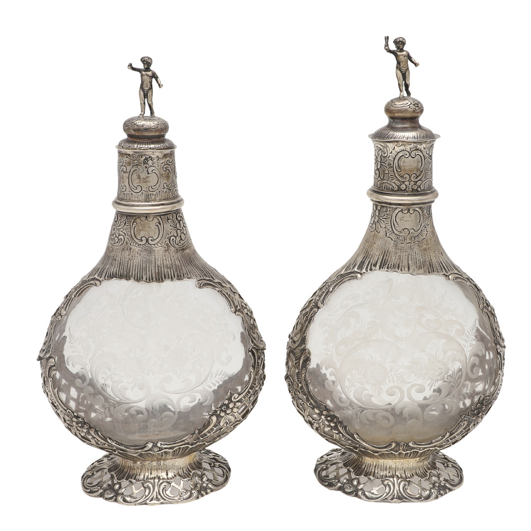 A PAIR OF LATE 19TH/ EARLY 20TH CENTURY GERMAN SILVER MOUNTED DECANTERS.