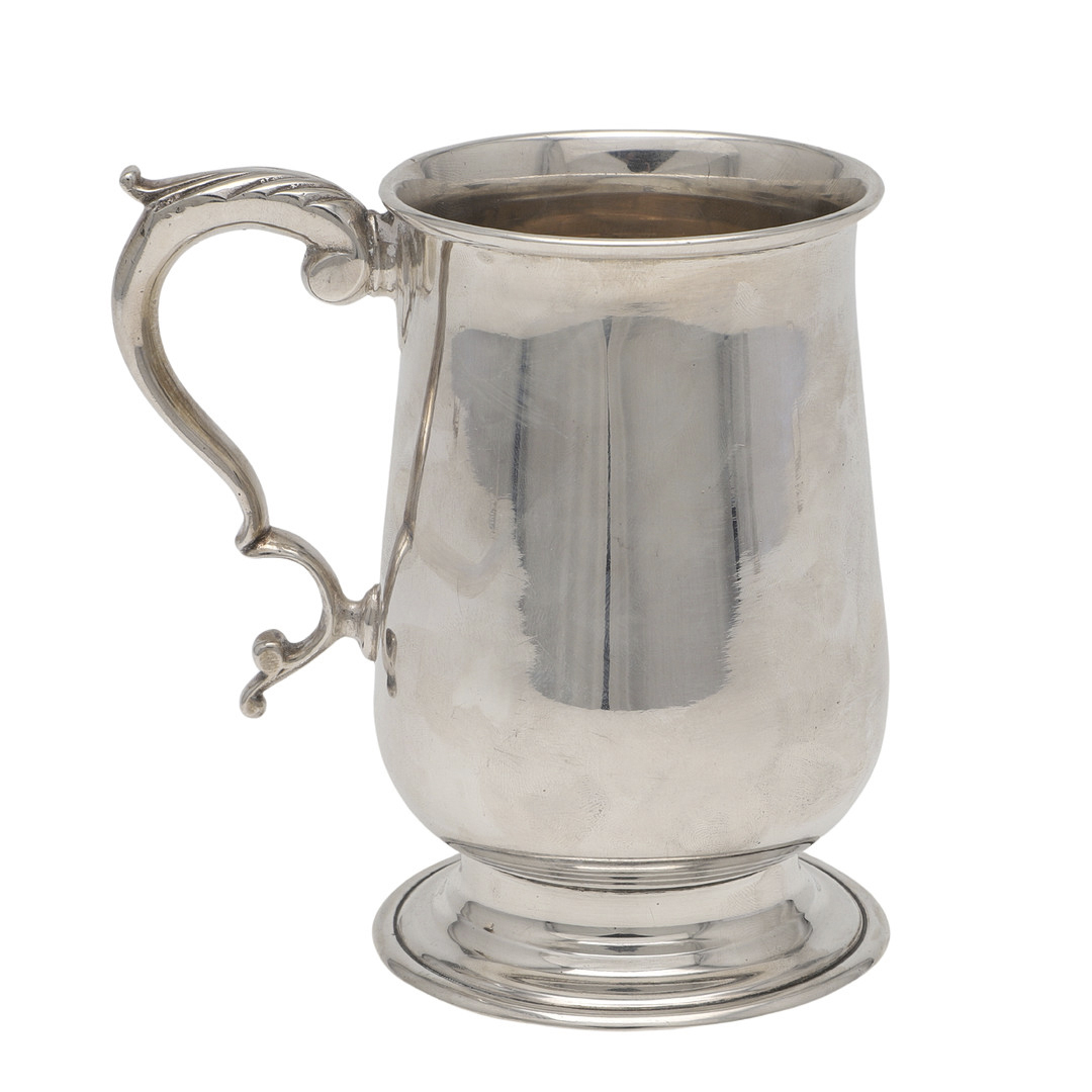 A MID-20TH CENTURY SILVER MUG.