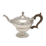 A GEORGE III SILVER TEA POT.