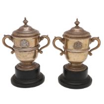 A NEAR PAIR OF ELIZABETH II SILVER TWO-HANDLED CUPS & COVERS.