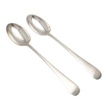 A NEAR PAIR OF LATE VICTORIAN/ EDWARDIAN SILVER SERVING OR BASTING SPOONS.